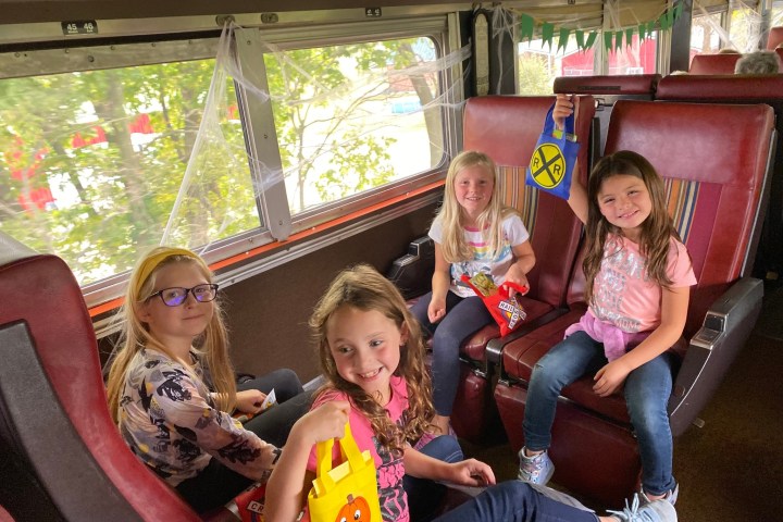 a group of young children sitting next to a child