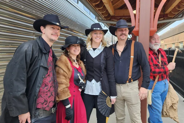 a group of people standing in front of a crowd posing for the camera