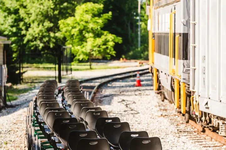 a train traveling down a dirt road