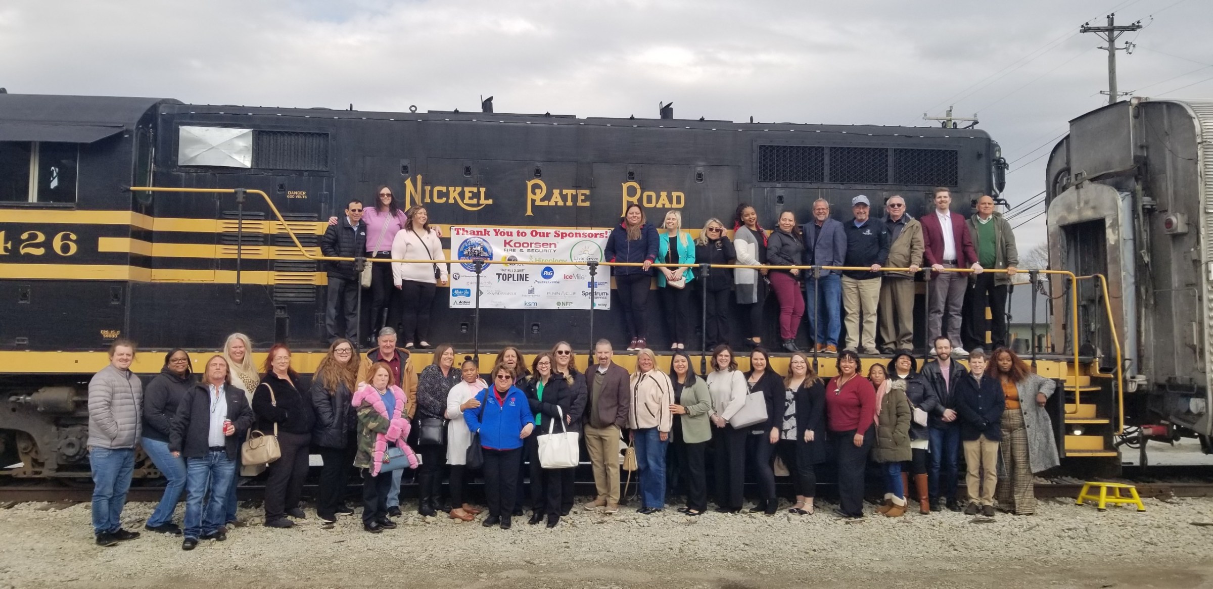 a group of people standing in front of a crowd posing for the camera