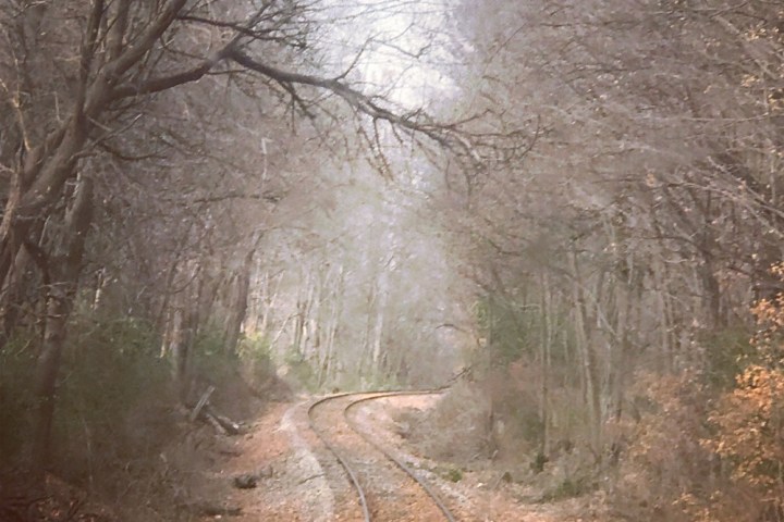 a train traveling down a dirt road