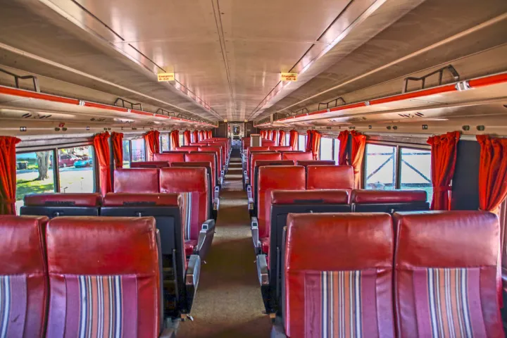 a train that is sitting on a chair in a room