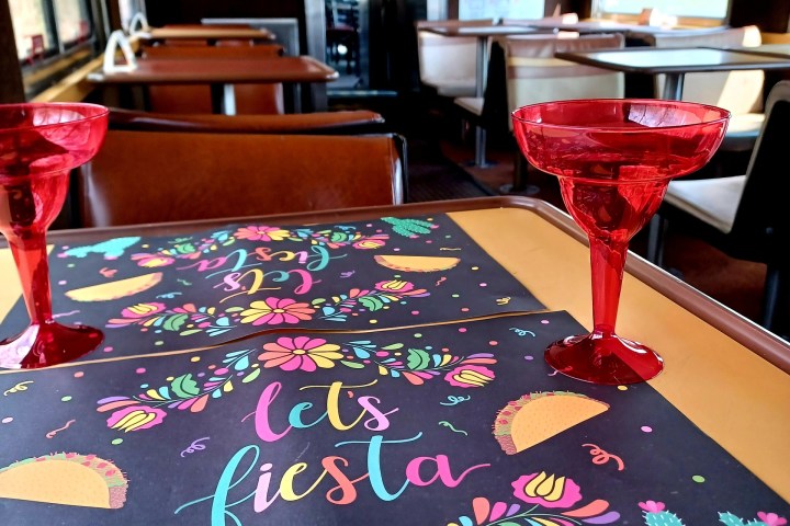 a bedroom with a bed and a chair in a room