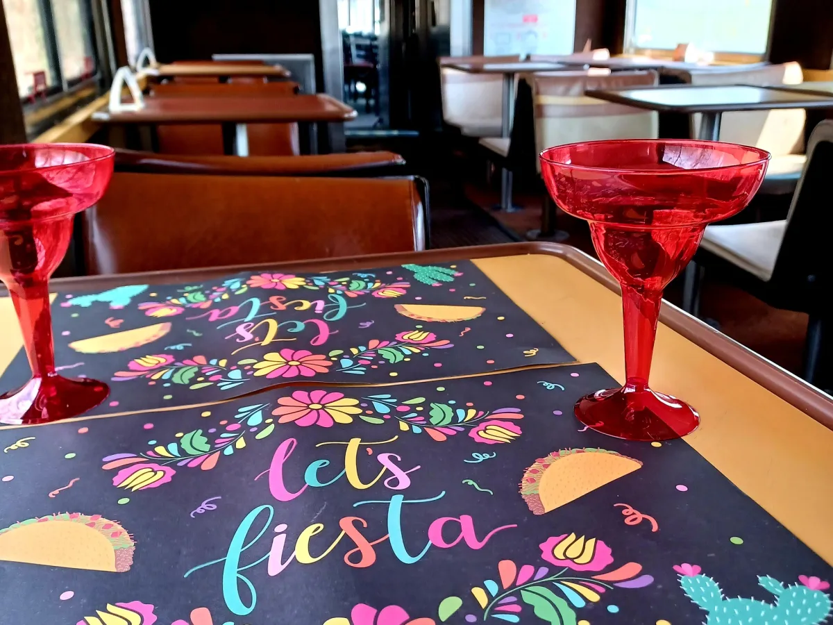 a bedroom with a bed and a chair in a room