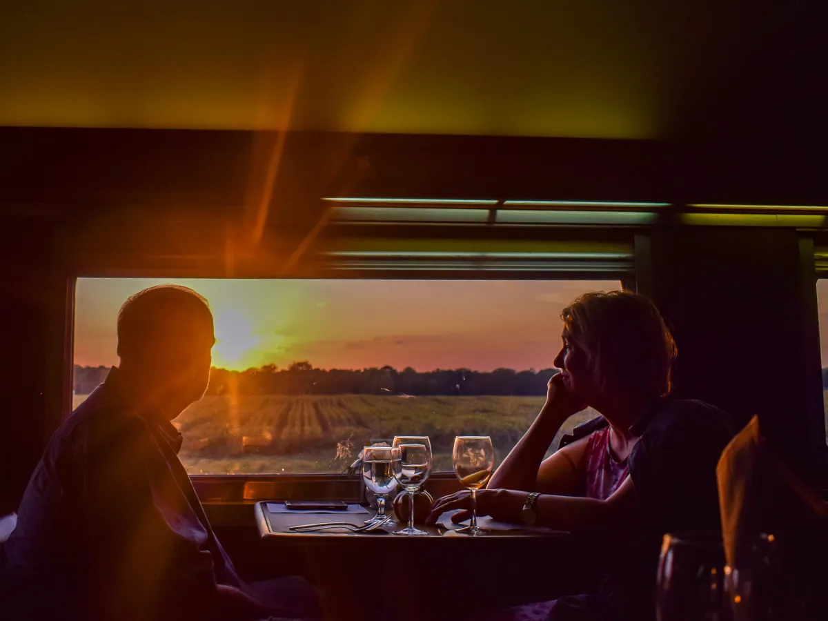 a group of people sitting at a table in a dark room