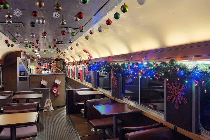 Festively decorated train interior with ornaments and garlands