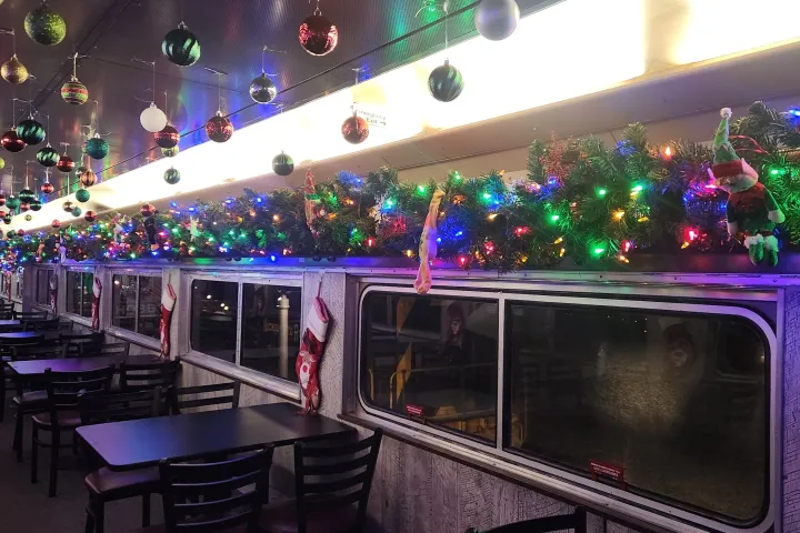 Festively decorated diner with lights, ornaments, and garlands.